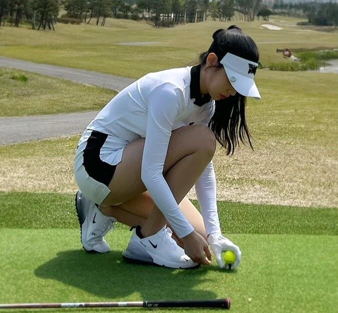 Cho Hyun, who's wearing a golf outfit.