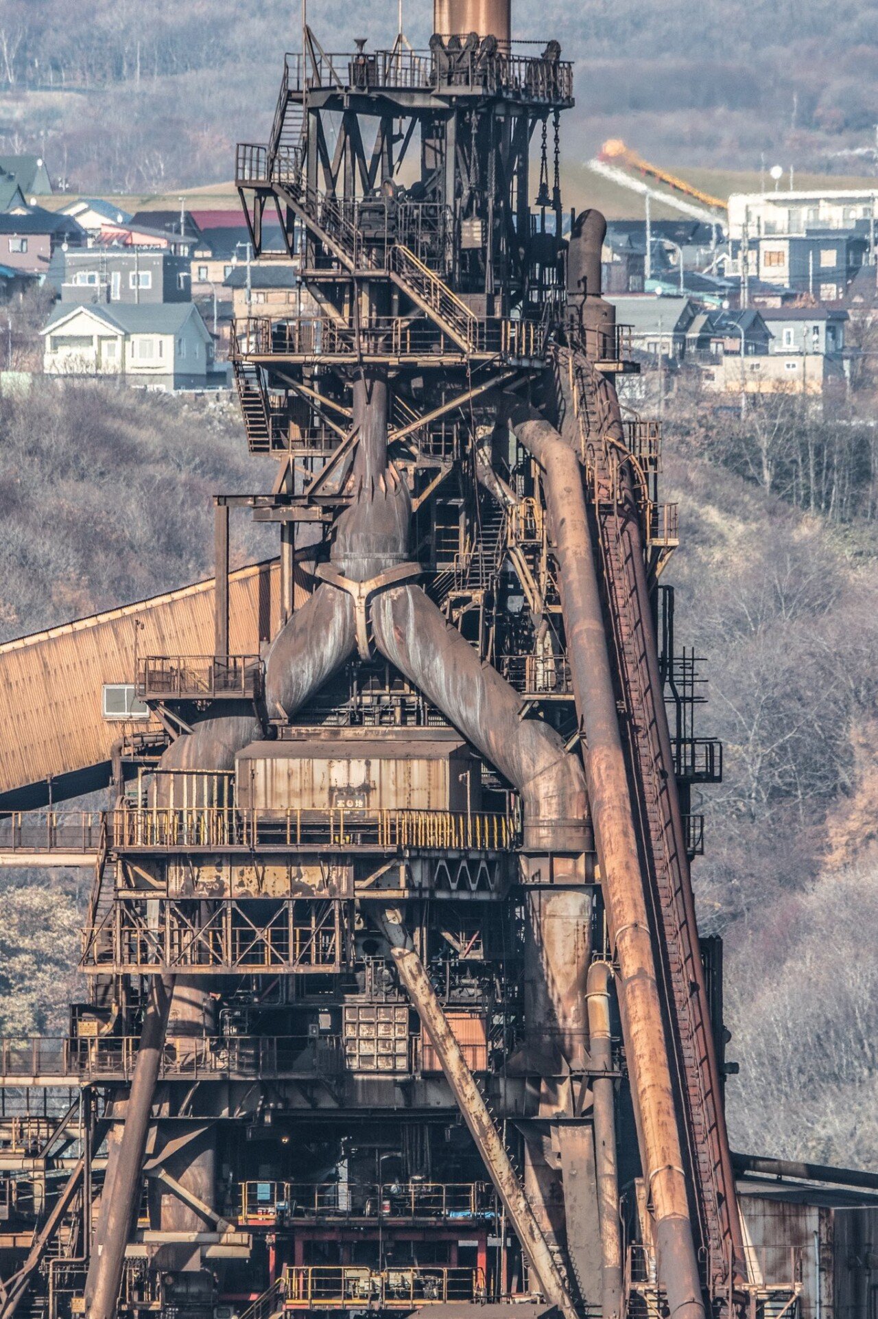 A giant t-shirt lying rusted in the factory area.