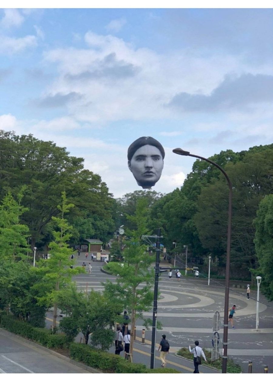 a mysterious face floating over Tokyo