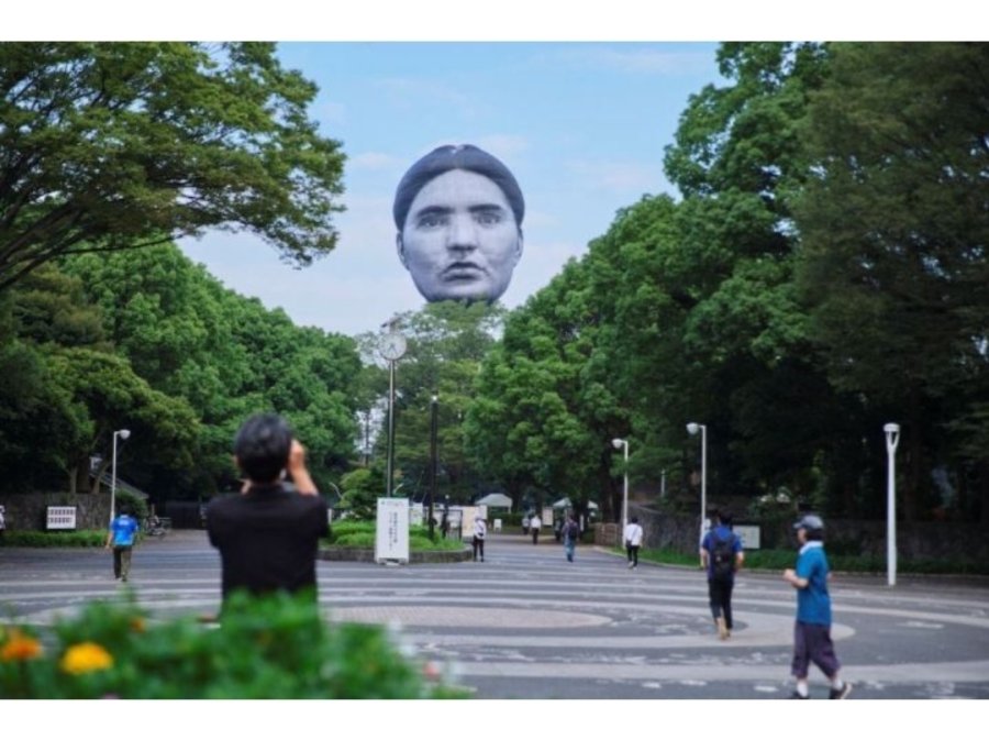 a mysterious face floating over Tokyo