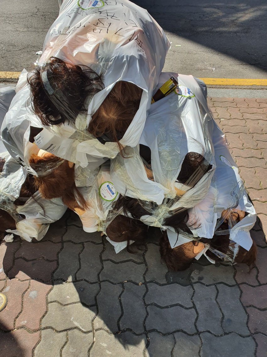 Garbage bags in front of the hair salon academy.