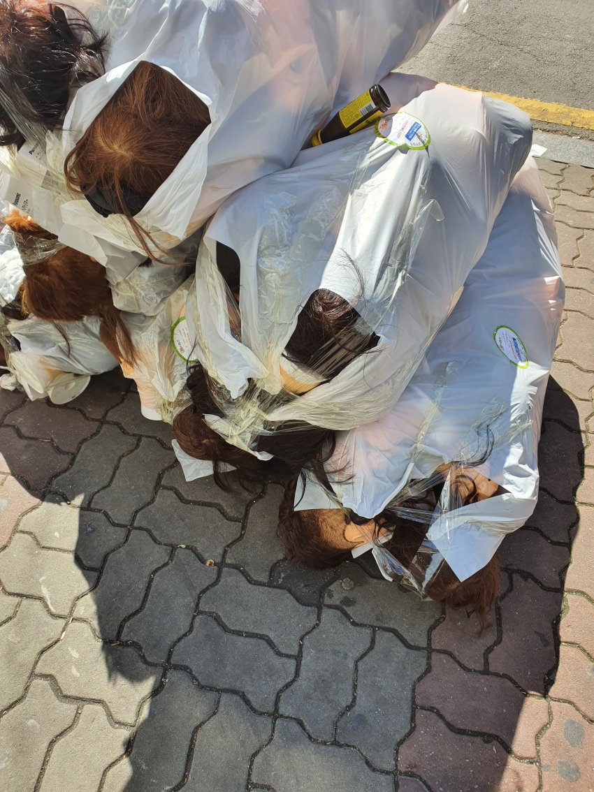 Garbage bags in front of the hair salon academy.