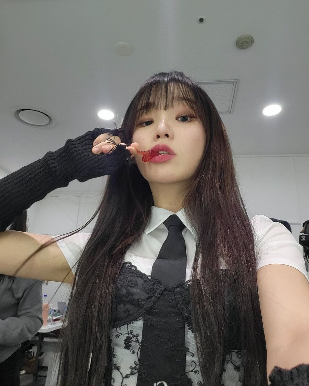 OH MY GIRL's Seunghee with a black lace bra on the outside.