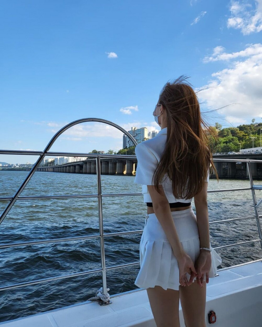 Lee Mi-Joo on a yacht wearing a white tennis skirt.