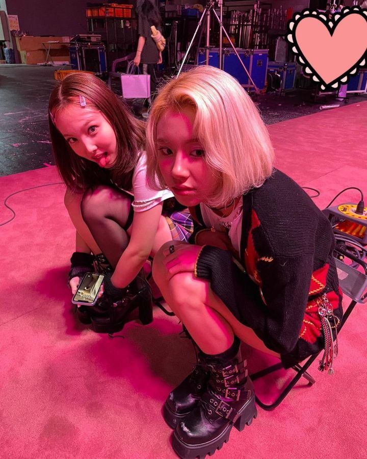 TWICE NAYEON and CHAEYOUNG are sitting on a small chair